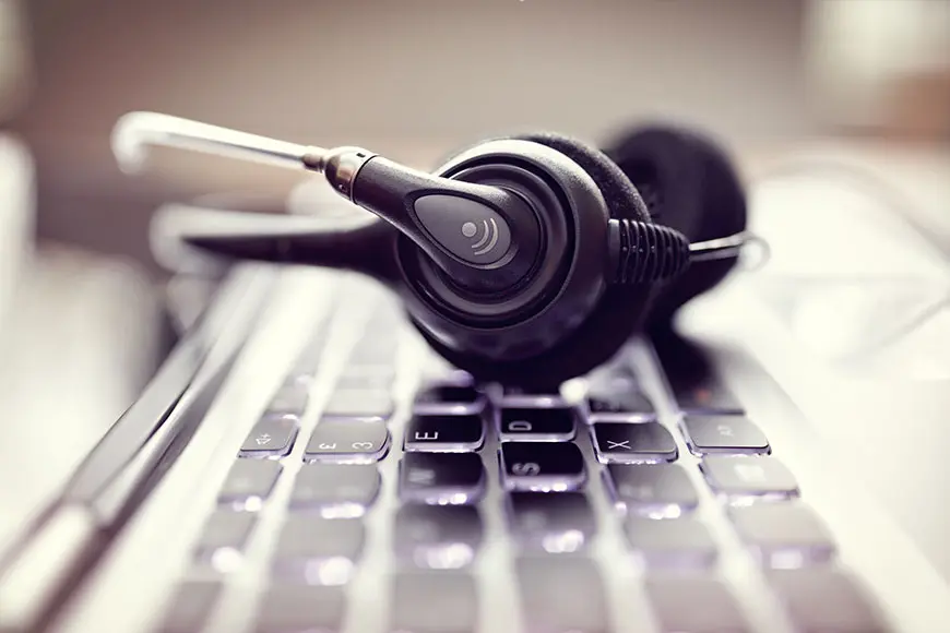 A support headset resting on a laptop keyboard